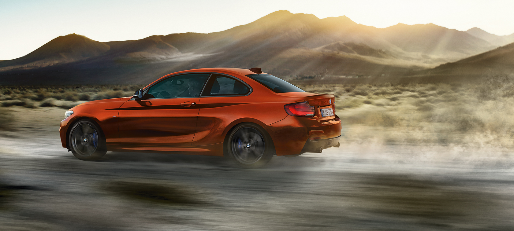 Driving dynamics BMW M240i Coupé F22 2017 Sunset Orange metallic side view