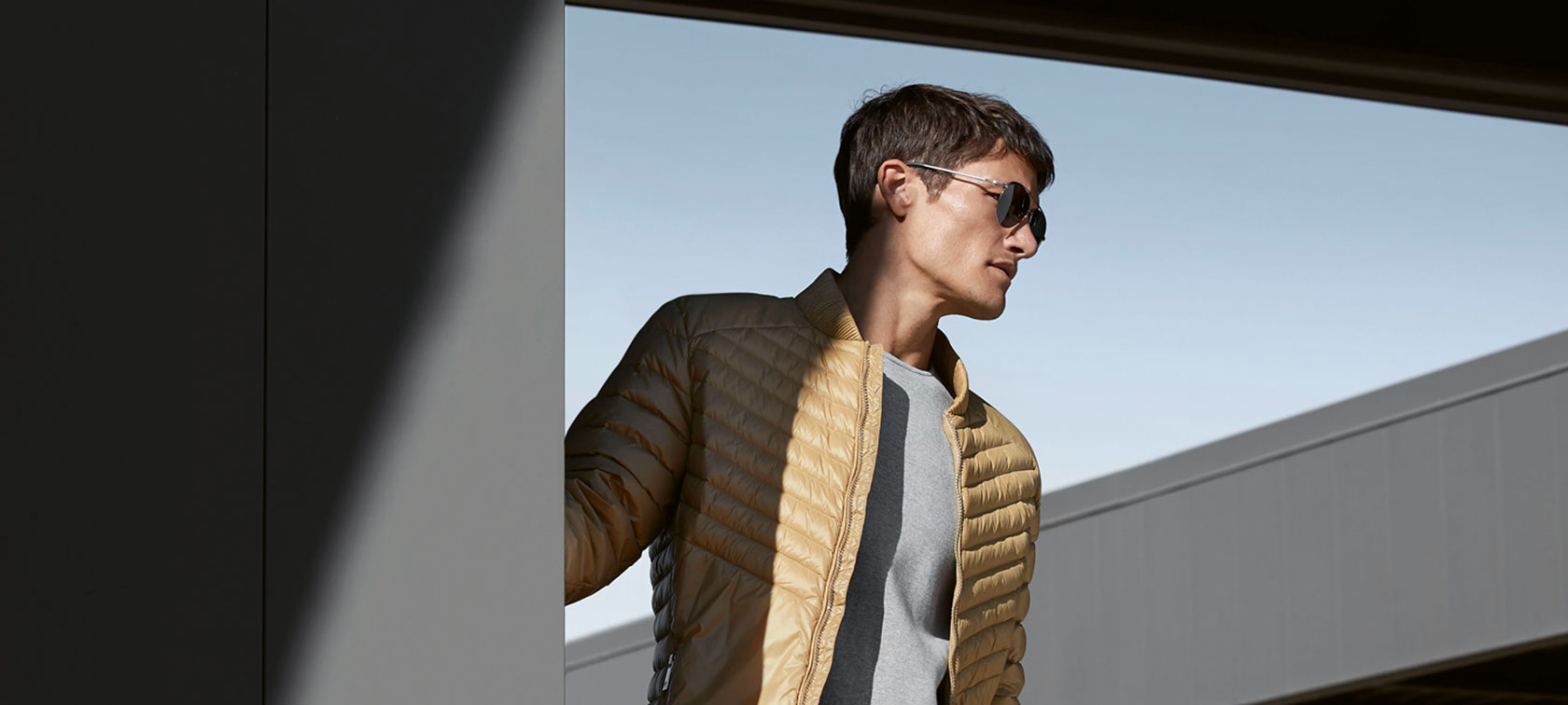 The picture shows a young model wearing the BMW Soft Down Jacket for men.